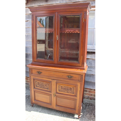 449 - A late 19th century carved walnut bookcase, the upper section enclosed two glazed panel doors over t... 