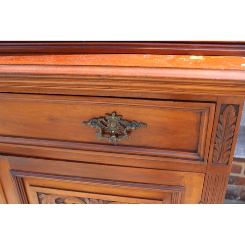 449 - A late 19th century carved walnut bookcase, the upper section enclosed two glazed panel doors over t... 