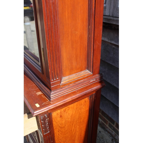 449 - A late 19th century carved walnut bookcase, the upper section enclosed two glazed panel doors over t... 