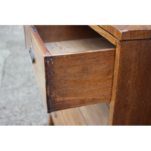 450 - A Georgian mahogany and ebony strung chest of two short and three long graduated drawers with emboss... 