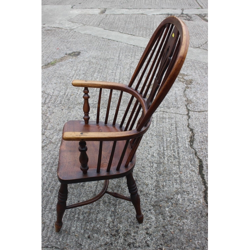 451 - A Windsor farmhouse elbow chair with pierced splat back panel seat and crinoline stretchered support... 