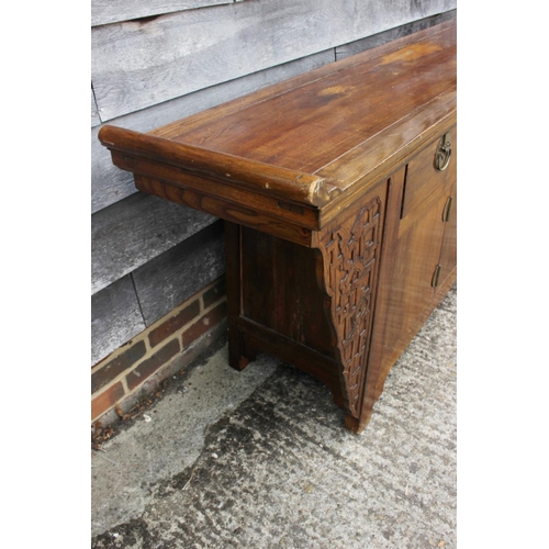 452 - An antique Chinese elm altar chest, fitted three drawers over cupboards enclosed four doors, 82