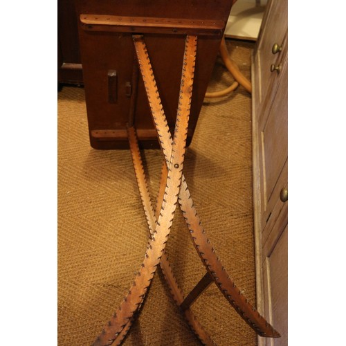 537 - An early 20th century pokerwork folding table, on 'X' frame supports, 30