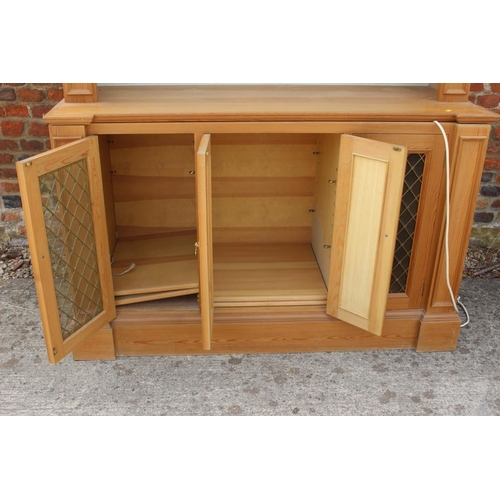 559 - A pine side cupboard, fitted two drawers over two doors, on bun feet, 35