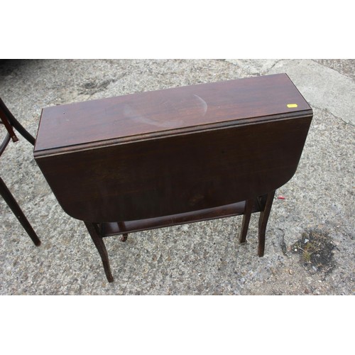 511 - An early 20th century carved walnut circular top two-tier occasional table, on panel supports, 18 1/... 