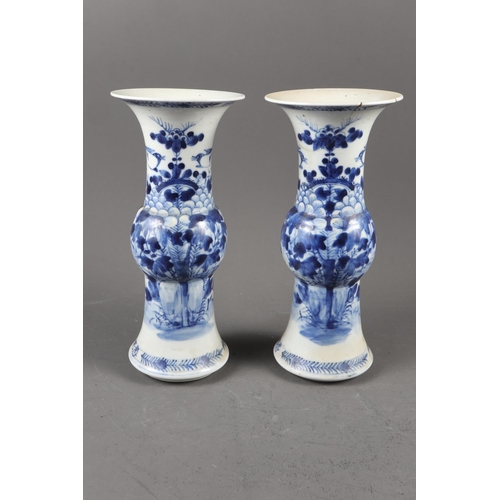 119 - A pair of Chinese blue and white gu vases with floral decoration and double ring marks to base, 10