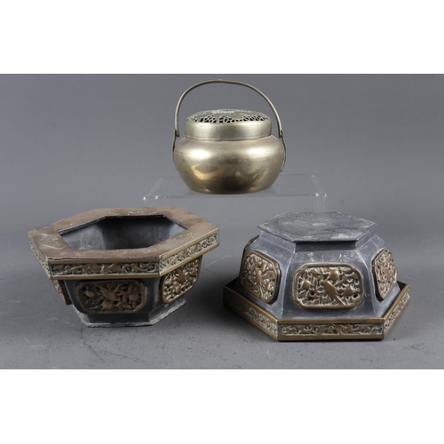 131 - A Chinese white metal hand warmer and a pair of lead and brass jardiniere stands, 6 1/2