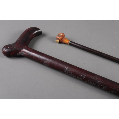 191 - An evening cane with carved boxwood and horn mounted boxer head terminal, 30