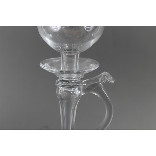 36 - A lacemaker's late 18th century blown glass lamp with handle, on folded foot, 10 1/2