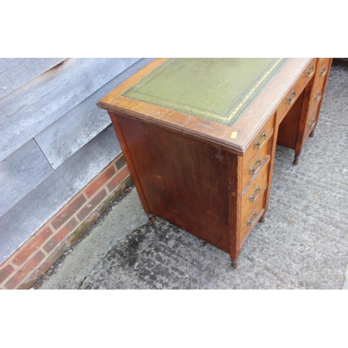 401 - An Edwardian oak twin pedestal desk tooled and gilt green leather top over nine drawers, 42