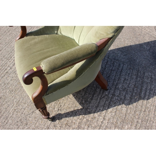 406 - A late Victorian spoon back open arm chair, button upholstered in a sage green velour, on turned and... 