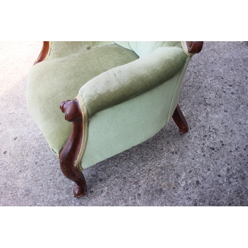 407 - A late Victorian mahogany showframe armchair, button upholstered in a sage green velour, on cabriole... 