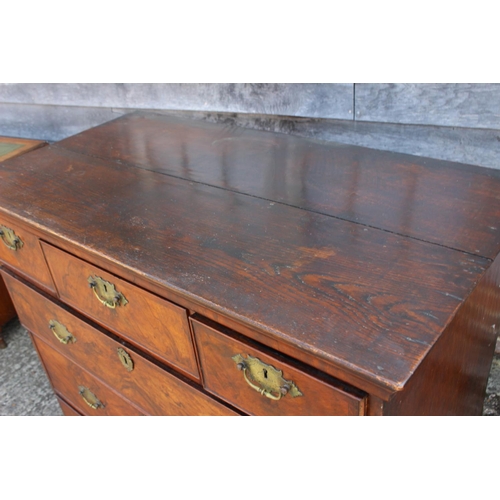 425 - A figured walnut and feather banded chest of two short and three long graduated drawers, on bun feet... 