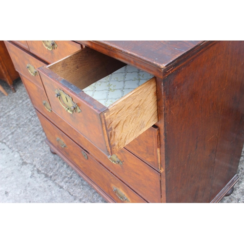 425 - A figured walnut and feather banded chest of two short and three long graduated drawers, on bun feet... 