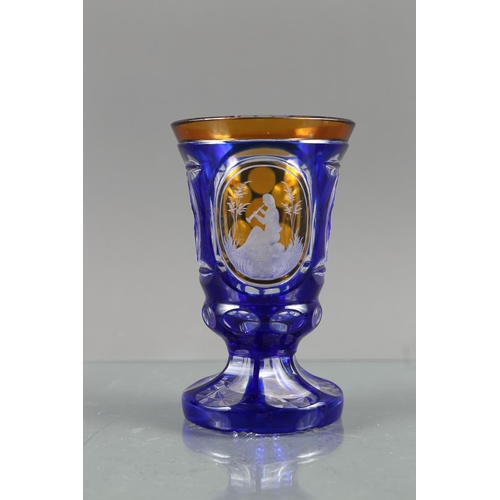 44 - A Continental blue and amber overlaid vase, decorated man playing a clarinet, another similar, ename... 