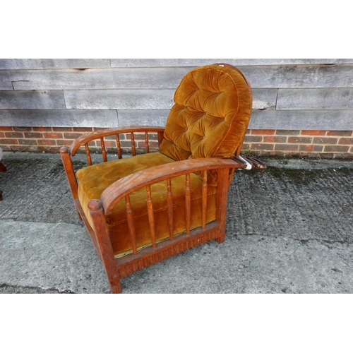 453 - A Liberty style oak framed reclining armchair with loose cushions upholstered in an old gold velvet