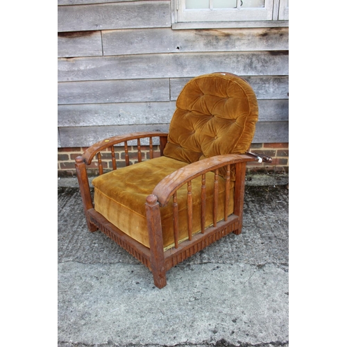 453 - A Liberty style oak framed reclining armchair with loose cushions upholstered in an old gold velvet