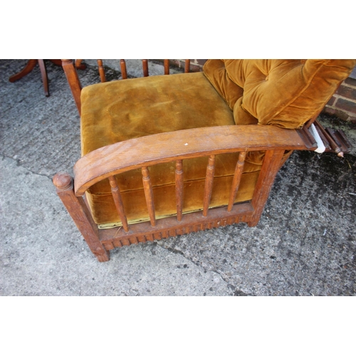 453 - A Liberty style oak framed reclining armchair with loose cushions upholstered in an old gold velvet