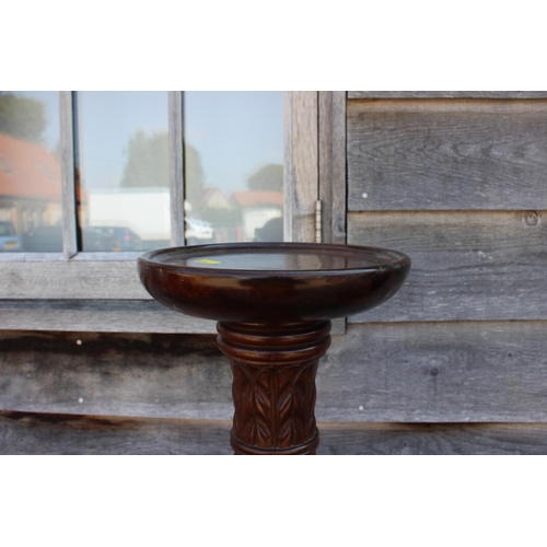 489 - A mahogany torchere stand with twisted fluted column, on tripod supports, 52 1/2