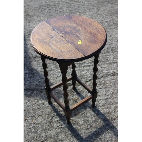 498 - A walnut low two-tier occasional table, on turned supports with galleried undertier, 21