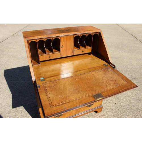 528 - A Heals 1930s walnut and banded fall front bureau with fitted interior over four long drawers, on br... 