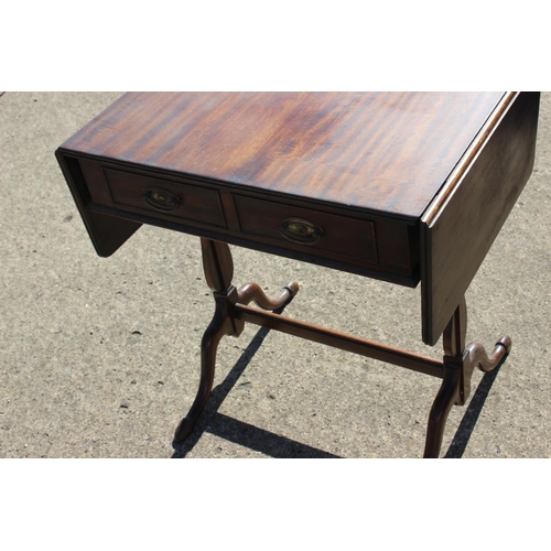 532 - A mahogany sofa table, fitted two drawers, on turned and stretchered splay supports, 24