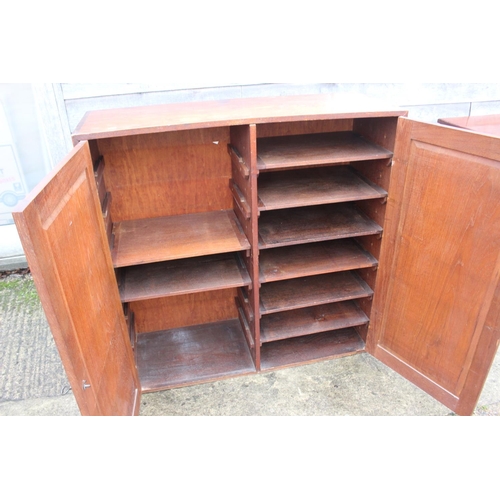 535 - A mahogany cupboard, interior fitted twelve shelves enclosed two panel doors, 42