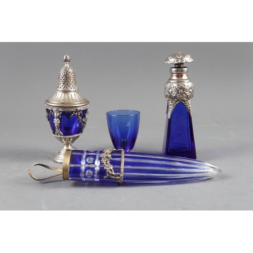 54 - A blue glass sugar dredger with white metal mounts, a similar wall pocket, a blue glass scent bottle... 