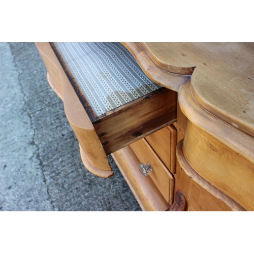 556 - A late 19th century waxed pine double serpentine front chest of eight drawers with glass knob handle... 