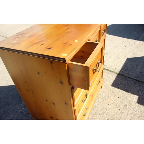 565 - A waxed pine chest of three small drawers and three long drawers, on bracket feet, 36