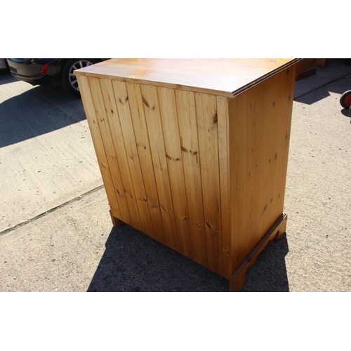 565 - A waxed pine chest of three small drawers and three long drawers, on bracket feet, 36