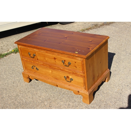 568 - A pair of pine bedside chests of three drawers, 16