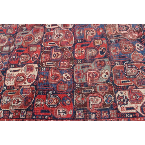 574 - A Caucasian tribal wool rug with stylised cypress tree and geometric designs with multi-guard border... 