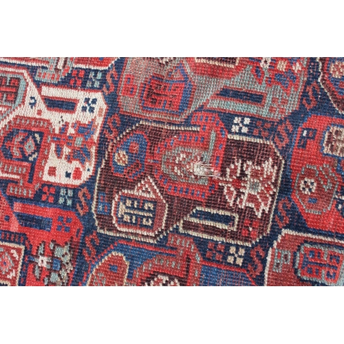 574 - A Caucasian tribal wool rug with stylised cypress tree and geometric designs with multi-guard border... 