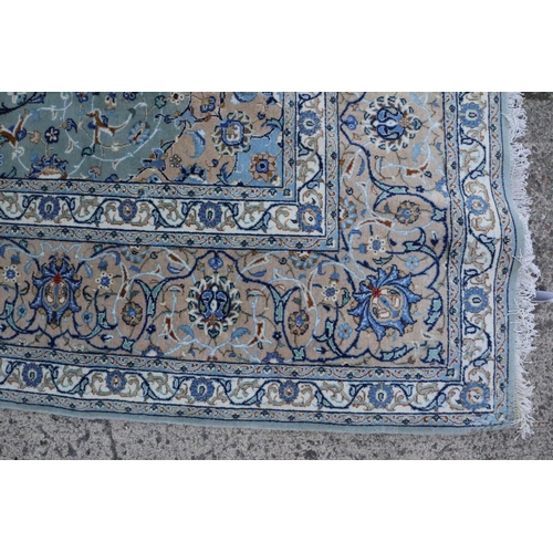 585 - A Keshan carpet with central star and all-over foliate design on a grey green ground and multi-borde... 