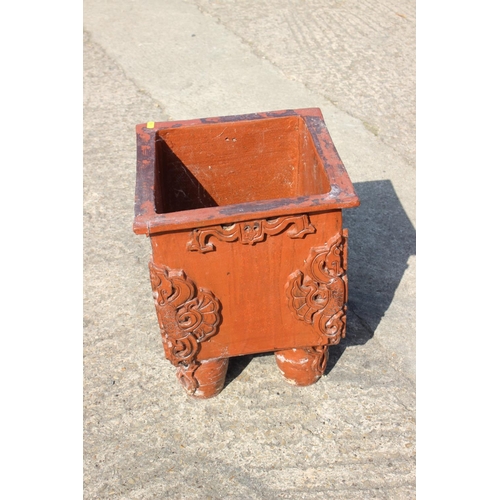 595 - An archaic Chinese style stoneware square jardiniere with applied decoration, on turned and tapering... 