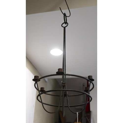 154 - A cast iron six-tier pan stand, on lion paw feet, and a wrought iron six-light chandelier