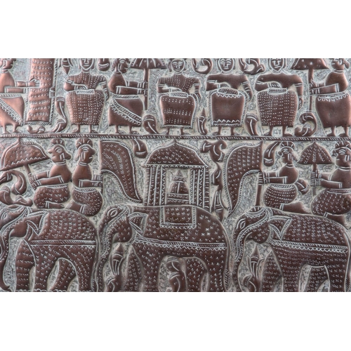 156 - A 19th century Indian embossed copper panel with elephant and figure decoration, 12