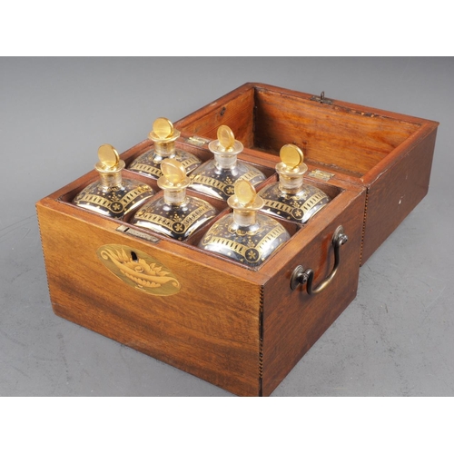 215 - A late Georgian mahogany and inlaid two-handle decanter box, containing six gilt decorated decanters... 