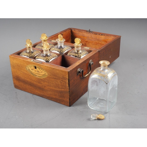 215 - A late Georgian mahogany and inlaid two-handle decanter box, containing six gilt decorated decanters... 