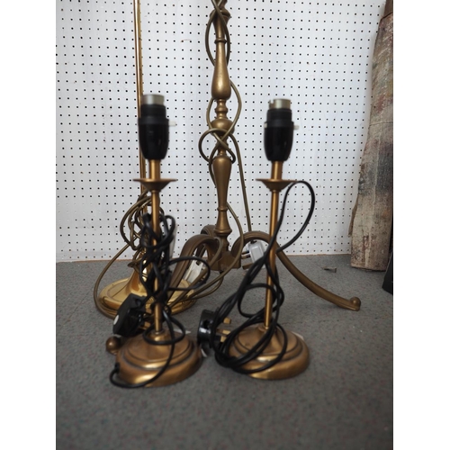 226 - A brass standard lamp, on tripod supports, 48 3/4