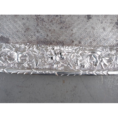 270 - A white metal square card tray with embossed floral decoration, on paw feet, 8 3/4