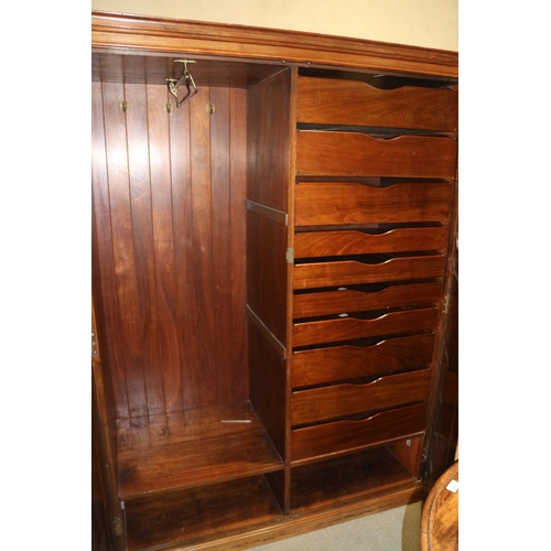 444 - A gentleman's early 20th century walnut wardrobe with interior fitted hanging compartment and nine d... 