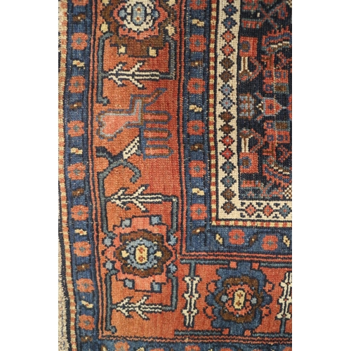 589 - A Herati rug with all-over design on a dark blue ground and triple bordered, in shades of red, blue ... 