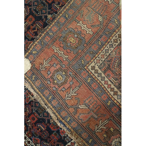 589 - A Herati rug with all-over design on a dark blue ground and triple bordered, in shades of red, blue ... 