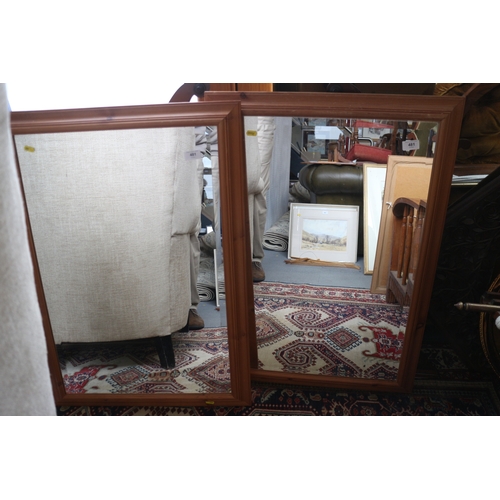 481 - A pair of rectangular pine framed wall mirrors with bevelled edges, 19 1/2