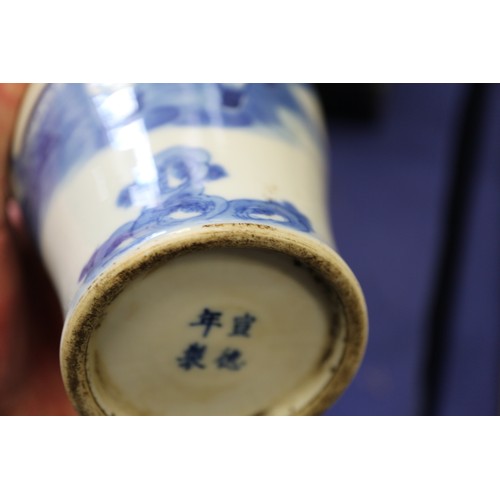 119 - A pair of Chinese blue and white gu vases with floral decoration and double ring marks to base, 10