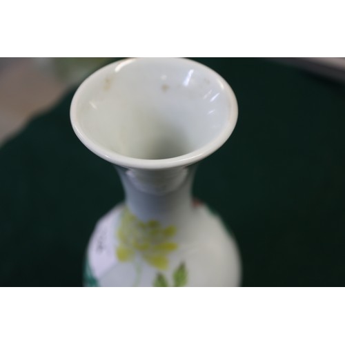 124 - A Chinese famille verte baluster vase with flower and leaf decoration, 7 3/4