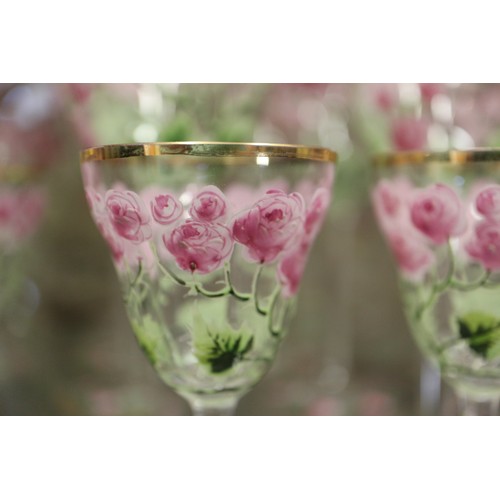 56 - An early 20th century Continental glass table service with enamelled pink cabbage rose decoration an... 