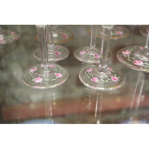 56 - An early 20th century Continental glass table service with enamelled pink cabbage rose decoration an... 